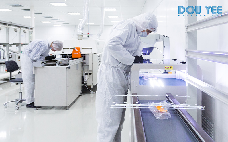 Workers in full cleanroom suits.